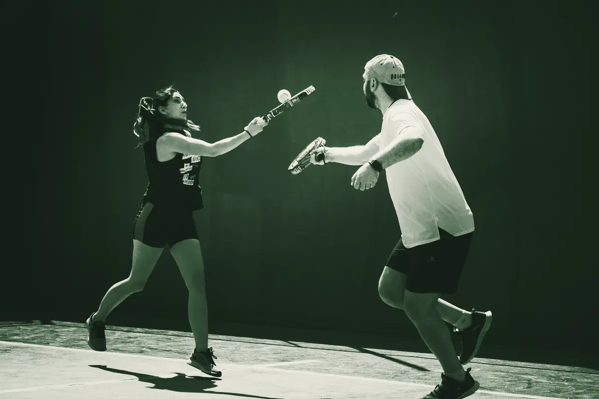 A mixed pair rallying at the net