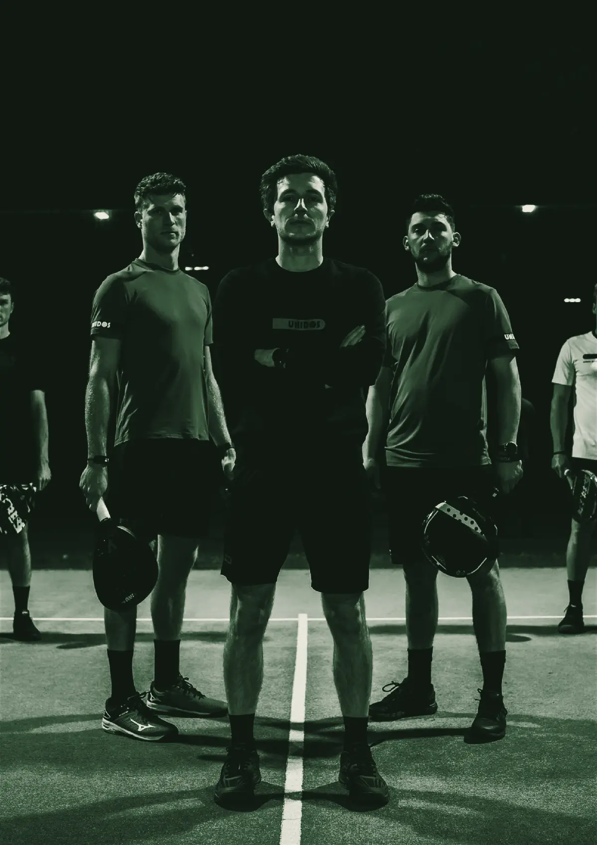 A padel team standing in a line on court